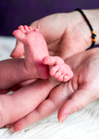 Handles and legs of the newborn baby