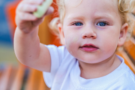Little cute smiling girl on the childrens outdoor playgroundの写真素材
