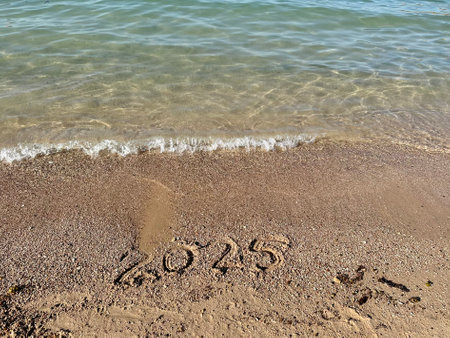 Year 2025 Written in Sand. Christmas