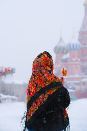 A woman in a Russian folk headscarf on her head in the Moscowの写真素材