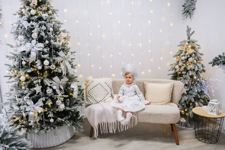Girl in the costume of the Snow Maiden in New Years decorationsの写真素材