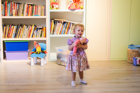 Beautiful blonde baby girl playing in kindergarten. High quality photoの写真素材
