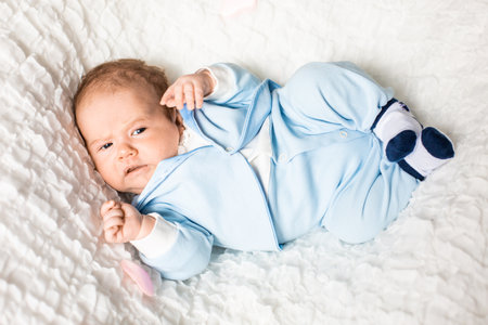 One month old baby girl on soft blanket. High quality photo