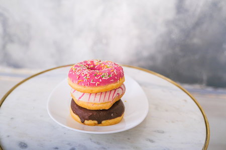 Three donuts on a colored background. High quality photoの写真素材