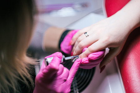 Young woman having manicure treatment in a beauty salon. High quality photoの写真素材