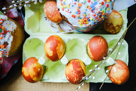 Close-up view of chicken eggs, homemade easter cake and willow twigs. High quality photo
