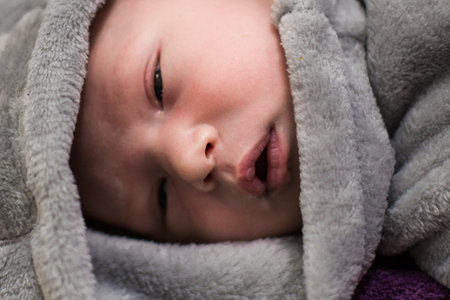 One month old baby girl on soft blanket. High quality photo