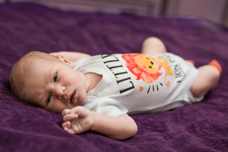 One month old baby girl on soft blanket. High quality photo
