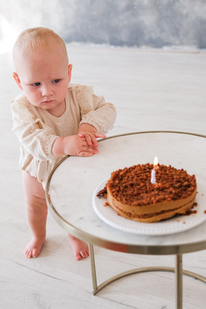 Baby girl celebrating her birthday with birthday cake. High quality photoの写真素材