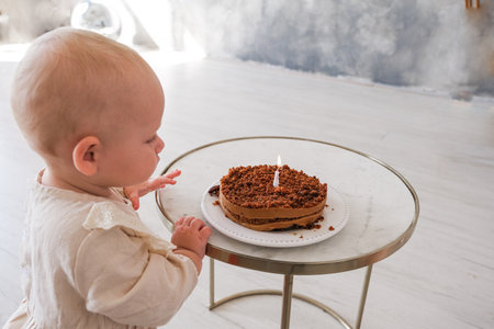 Baby girl celebrating her birthday with birthday cake. High quality photoの写真素材