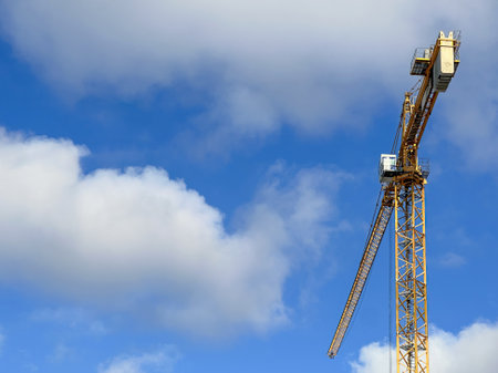Construction crane on cloud background. High quality photoの写真素材
