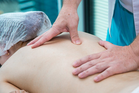 Close up of back massage procedure in spa salon. High quality photoの写真素材