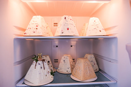 Moscow, Russia, 04/18/25. A row of cakes in a refrigerator, with one of them labeled "RK". The cakes are all different shapes and sizes, and they are all placed on the same shelfの写真素材