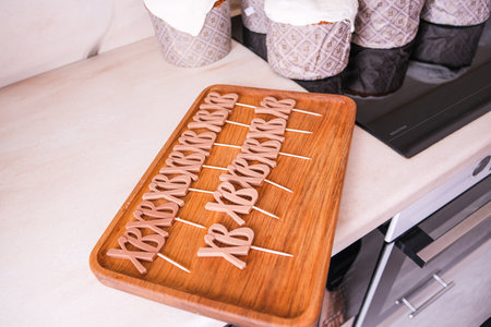 Moscow, Russia, 04/18/25. A wooden tray with a bunch of letters on it. The tray is on a counter next to a stoveの写真素材
