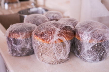 A group of pastries are covered in plastic wrap. The plastic wrap is covering the pastries to keep them fresh and prevent them from drying outの写真素材