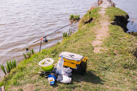 moscow, russia, 04/19/2025 A fishing trip is underway with a cooler and a bucket of water. The cooler is full of drinks and the bucket is full of water. The scene is peaceful and relaxing, with the waterの写真素材
