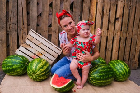 Happy mother and daughter with watermelons. High quality photoの写真素材