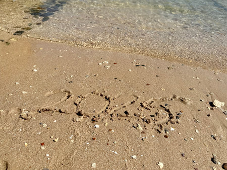 Year 2025 Written in Sand. High quality photo
