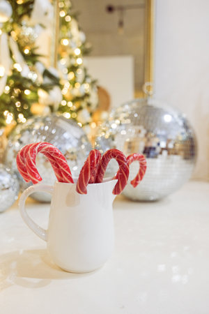 Composition with cup of hot drink, candy canes and Christmas tree background. High quality photoの写真素材