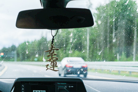 Moscow, Russia, 08/18/2025 Dirty car windshield with bird droppings, causing blurred vision while driving on highway, safety concept for road trip.の写真素材
