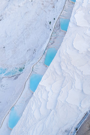 pamukkale, Turkiye, 07/08/2025 White travertine terraces and blue thermal pools. Geological formation with mineral-rich hot springs. Natural wonder for travel tourism.の写真素材