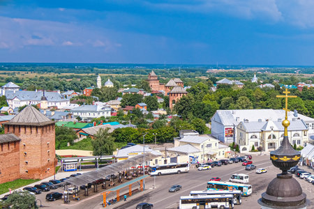 kolomna, russia, 23.07.2022 Aerial view of a historic city with green trees, traditional architecture, and a busy street filled with vehicles. The sky is partly cloudy.の写真素材