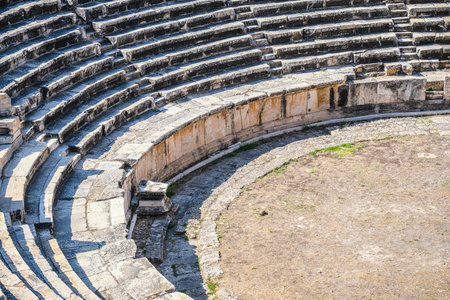 pamukkale, Turkiye, 07/08/2025 Ancient ruins of an amphitheater in Turkey with stone steps and arena ground. Historical travel and archeology concept.の写真素材