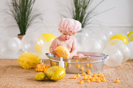 Baby in a basin with rubber ducks. High quality photoの写真素材