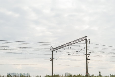 Russia, Saint Petersburg, 08/23/2025 Power lines and wires with an electricity pole under cloudy sky for infrastructure and electricity transmission conceptの写真素材