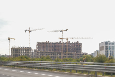 Russia, Saint Petersburg, 08/23/2025 Modern residential building construction site with multiple tower cranes. Urban development and new neighborhood creation concept. Real estate growth.の写真素材