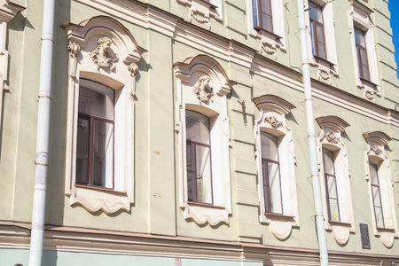 Russia, Saint Petersburg, 08/23/2025 Baroque building facade with ornate architectural details and narrow windows. European architectural style for travel and historical building concept.の写真素材