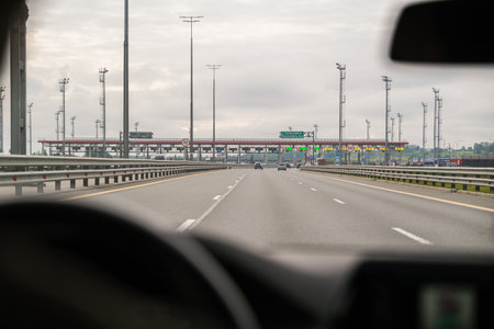 Russia, Saint Petersburg, 08/23/2025 View from inside a car of a highway approaching a toll road...