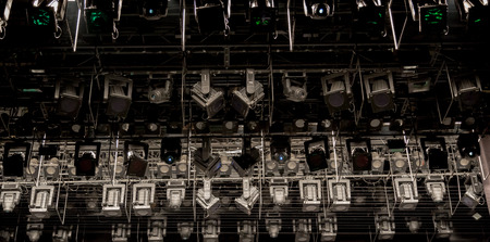 Lighting equipment, spotlights, projectors, scanners and head to the theater on the stageの写真素材