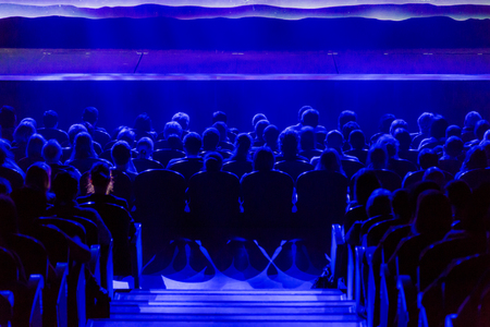 People in the auditorium looking at the stage. Shooting from the backの写真素材