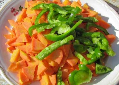 Chopped vegetables: carrots and green peppersの写真素材