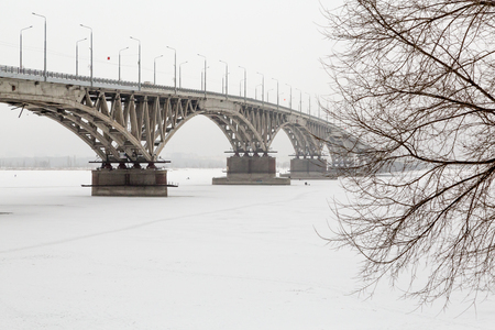 Road bridge over the Volga river in Saratov, Russia. Winter, ice on the riverの写真素材