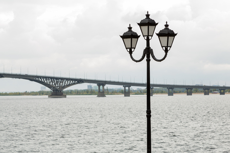 Bridge across the Volga river between the cities of Saratov and Engels, promenade, street light, cloud, Septemberの写真素材