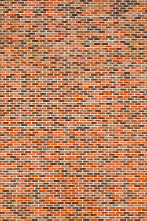 The brickwork is red-black with white seams. Texture, background. The wall of the building....