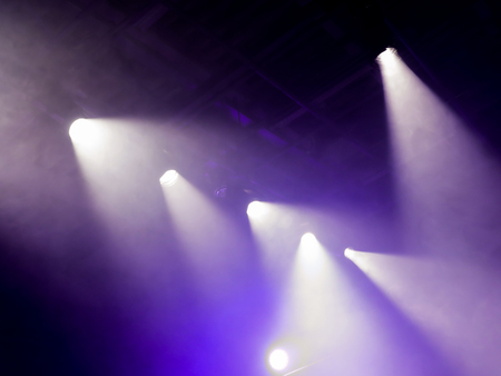 The light rays from the spotlight through the smoke. Lighting equipment on the ceiling. The stage of a theatre or night club. Show or performance.の写真素材