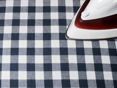 Ironing room. Iron on plaid fabric.の写真素材