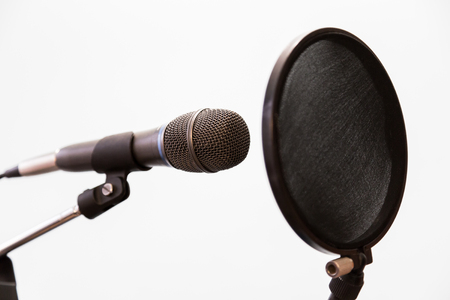 Cardioid condenser microphone and pop filter on a gray background. Home recording Studio.の写真素材