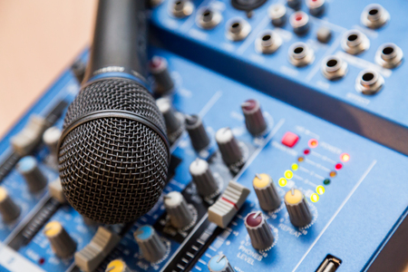 The equipment for recording. Microphone lying on sound mixing Board.