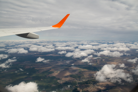 Photographing from a plane window. Flying a plane over the cloudsの写真素材