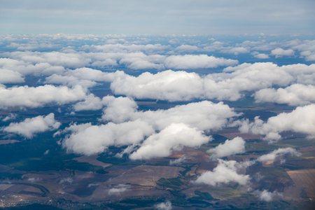 Photographing from a plane window. Flying a plane over the cloudsの写真素材