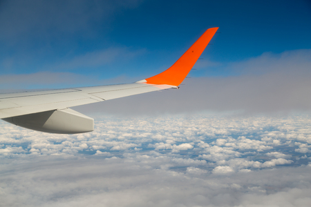 Photographing from a plane window. Flying a plane over the cloudsの写真素材