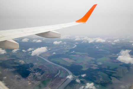 Photographing from a plane window. Flying a plane over the cloudsの写真素材