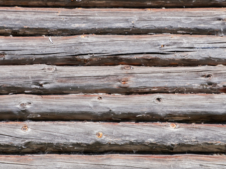 Wall of a wooden house built from logs. Textured background.の写真素材
