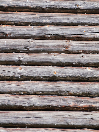 Wall of a wooden house built from logs. Textured background.の写真素材