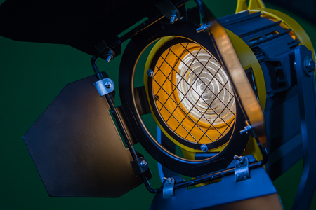 A spotlight with a Fresnel lens and a halogen lamp. Equipment for photographing and filming in the interior. Close-up.の写真素材
