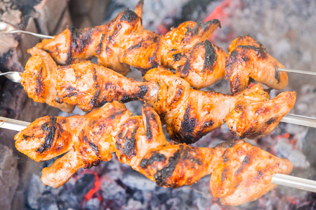 Chicken shish kebab roasting on the coals.の写真素材